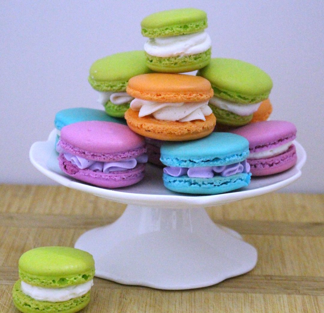 Behind the cake - colorful french macarons filled with buttercream.