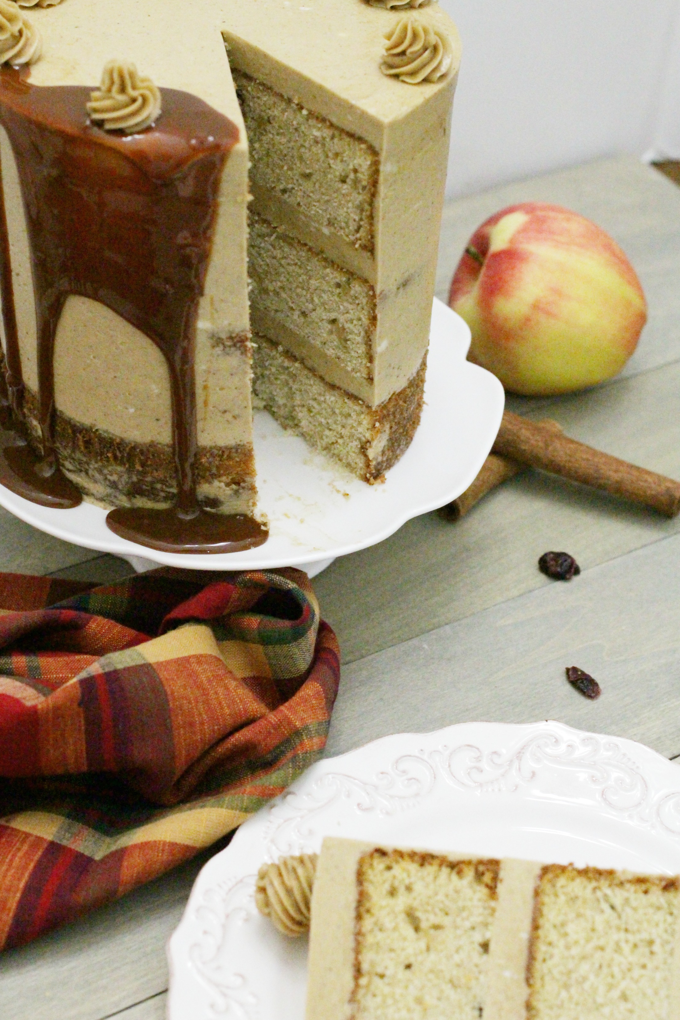 Behind the cake- Cranberry apple cake frosted with brown sugar spice Swiss meringue with dripping caramel