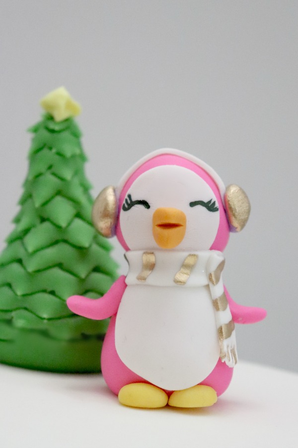 Behind the cake - Pink fondant penguin figurine cake topper